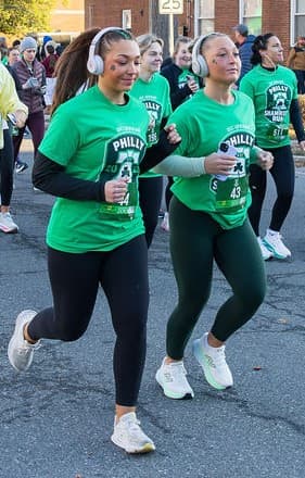 Runners wearing official Philly Shamrock Run shirts and race bibs at the 2026 Philadelphia 5K
